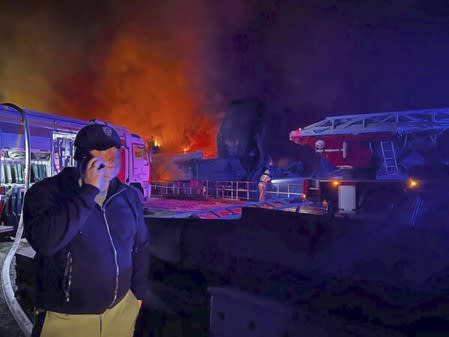 Mikhail Razvozhaev, the Russian-backed governor of Crimea, posted this photo of himself on the phone in the Sevastopol Shipyard on Wednesday, September 13. In the background appears to be the port side of a large landing craft that is on fire. Image: Telegram.